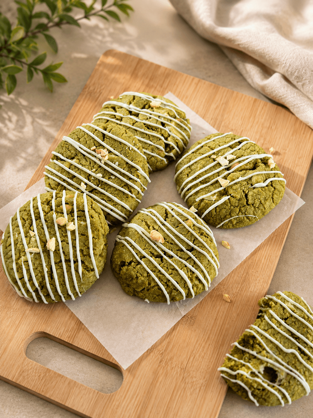 Matcha cookies with white icing drizzle and crushed nuts